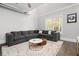 Bright living room with a large sectional sofa, a fluffy rug, and large window at 3371 Dogwood Dr # 220, Hapeville, GA 30354