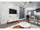 Comfortable living room featuring modern decor, flat screen tv, bright paint, hardwood floors, and inviting open-concept design at 3371 Dogwood Dr # 220, Hapeville, GA 30354