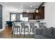 Open-concept living space with a kitchen island, bar stool seating, dining area, and living room at 3371 Dogwood Dr # 220, Hapeville, GA 30354