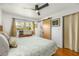 Sunlit bedroom featuring a ceiling fan, wood floors, and a charming barn door at 2382 Whites Mill Ln, Decatur, GA 30032