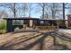 Charming single-story home featuring a black exterior, a wooden porch, and a well-manicured front yard at 2382 Whites Mill Ln, Decatur, GA 30032