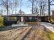 Charming single-story home featuring a black exterior, a wooden porch, and a well-manicured front yard at 2382 Whites Mill Ln, Decatur, GA 30032