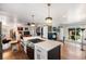 Bright kitchen open to the living area, featuring island seating, hardwood floors, and access to outdoor space at 2382 Whites Mill Ln, Decatur, GA 30032