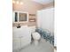 Functional full bathroom with a vanity, toilet, and shower with white and green foliage curtain at 5740 Terremont Cir, Norcross, GA 30093
