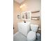 Cozy bathroom features a white vanity and toilet, complemented by stylish shelves and neutral wall color at 5740 Terremont Cir, Norcross, GA 30093
