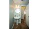 Bathroom featuring a pedestal sink, round mirror, and decorative marble flooring at 5740 Terremont Cir, Norcross, GA 30093
