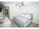 Cozy bedroom with light blue bed frame, ceiling fan, and light colored wood flooring at 5740 Terremont Cir, Norcross, GA 30093