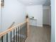 Hallway features a light-colored wood floor, stairs, and a metal accented display table at 5740 Terremont Cir, Norcross, GA 30093