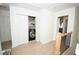 Hallway with bright, natural light, closet with washer, and light wood floors at 5740 Terremont Cir, Norcross, GA 30093