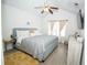 Comfortable main bedroom with a ceiling fan, TV, and window at 5740 Terremont Cir, Norcross, GA 30093