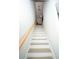 Light-colored wood staircase leading up to the second level with a modern handrail at 5740 Terremont Cir, Norcross, GA 30093