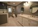Well-lit bathroom featuring white double vanity, hex tile floor, and shower at 1075 Winding Branch Ln, Atlanta, GA 30338