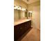 Spacious bathroom featuring a double vanity with marble countertop and updated fixtures at 1075 Winding Branch Ln, Atlanta, GA 30338