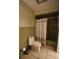 Bathroom featuring a shower with retro green tile and shower curtain, and a matching toilet at 1075 Winding Branch Ln, Atlanta, GA 30338