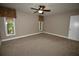 Neutral bedroom showcasing two sunny windows, a ceiling fan, and neutral carpet at 1075 Winding Branch Ln, Atlanta, GA 30338
