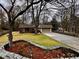 Charming single-story home featuring a well-manicured lawn and a paved driveway leading to an attached garage at 1075 Winding Branch Ln, Atlanta, GA 30338
