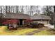 Exterior shot showing the unique roof style and yard with stone pathway and trees at 1075 Winding Branch Ln, Atlanta, GA 30338
