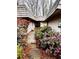 Inviting home entrance featuring a wooden walkway and lush landscaping with flowering bushes at 1075 Winding Branch Ln, Atlanta, GA 30338