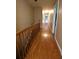 The upstairs hallway features hardwood flooring and a wooden railing at 1075 Winding Branch Ln, Atlanta, GA 30338