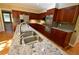Modern kitchen boasts stainless steel appliances, granite countertops, and custom cabinetry at 1075 Winding Branch Ln, Atlanta, GA 30338