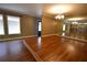 Bright living room features gleaming hardwood floors, large windows, and stylish chandelier at 1075 Winding Branch Ln, Atlanta, GA 30338