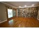 Spacious living room featuring wood floors and a unique stone accent wall at 1075 Winding Branch Ln, Atlanta, GA 30338