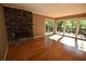 Light-filled living room with stone fireplace and sliding glass doors to the deck at 1075 Winding Branch Ln, Atlanta, GA 30338