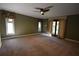 Large main bedroom with ceiling fan and sliding doors to outdoor deck at 1075 Winding Branch Ln, Atlanta, GA 30338