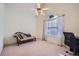 Spare bedroom with a chaise lounge, desk, carpet, a ceiling fan, and natural light at 1312 Birch Ct, Lithonia, GA 30058
