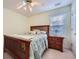 Cozy bedroom with a wood bed frame, and a small wooden nightstand adjacent to the bed at 1312 Birch Ct, Lithonia, GA 30058