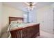 Well-lit bedroom with wood bed frame, ceiling fan, and a closet with white, double doors at 1312 Birch Ct, Lithonia, GA 30058