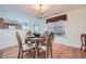Bright dining area with hardwood floors, chandelier, and views into the kitchen at 1312 Birch Ct, Lithonia, GA 30058