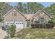 Charming brick home with a well-manicured lawn and a two-car garage at 1312 Birch Ct, Lithonia, GA 30058