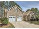Attractive brick home with attached two-car garage, driveway and manicured landscaping at 1312 Birch Ct, Lithonia, GA 30058