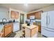 Traditional kitchen features wood cabinets, tile flooring, and a functional center island at 1312 Birch Ct, Lithonia, GA 30058