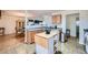 Well-lit kitchen with a breakfast bar island and an open view of the dining area at 1312 Birch Ct, Lithonia, GA 30058