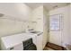 Well-equipped laundry room with modern washer, dryer, and storage shelving above at 1312 Birch Ct, Lithonia, GA 30058