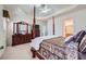 Comfortable main bedroom with a four-poster bed, dresser, and carpeted floors at 1312 Birch Ct, Lithonia, GA 30058