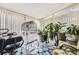 Bright sun room with many windows, potted plants, patterned rug, and a stationary bike at 1312 Birch Ct, Lithonia, GA 30058