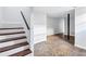 Finished basement with stairs, tile flooring, and painted support beam at 1328 Sharon Street Nw, Atlanta, GA 30314