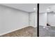 Open finished basement with tiled floors, a white door, and a central structural post at 1328 Sharon Street Nw, Atlanta, GA 30314