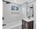 Elegant bathroom featuring marble tiling, sleek fixtures, and a modern vanity with a stylish mirror at 1328 Sharon Street Nw, Atlanta, GA 30314