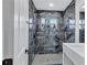 Luxurious bathroom featuring marble-style tile, a rain shower head, and contemporary fixtures and vanity at 1328 Sharon Street Nw, Atlanta, GA 30314