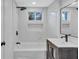 Bright bathroom featuring modern fixtures, a bathtub, and tile surround at 1328 Sharon Street Nw, Atlanta, GA 30314