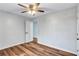 Bedroom with hardwood floors, ceiling fan and a white door at 1328 Sharon Street Nw, Atlanta, GA 30314
