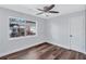 Bright bedroom with hardwood floors, ceiling fan, a double hung window, and fresh white trim at 1328 Sharon Street Nw, Atlanta, GA 30314