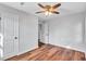 Spacious bedroom featuring hardwood floors, a ceiling fan and two doors at 1328 Sharon Street Nw, Atlanta, GA 30314