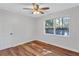 Bright bedroom featuring hardwood floors, a ceiling fan, and a window at 1328 Sharon Street Nw, Atlanta, GA 30314