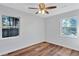 Inviting bedroom with hardwood floors, light gray paint, and plenty of natural light from two windows at 1328 Sharon Street Nw, Atlanta, GA 30314