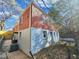 Side view of a brick house featuring a painted foundation and foliage at 1328 Sharon Street Nw, Atlanta, GA 30314
